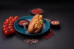 Hotdog with grilled sausage with cabbage, carrots and onions photo