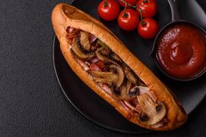 Hotdog with grilled sausage with bacon and mushrooms photo
