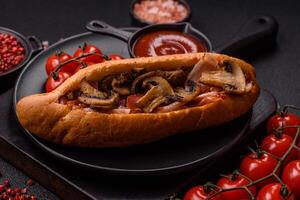 Hotdog with grilled sausage with bacon and mushrooms photo
