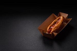 Hotdog with grilled sausage with bacon and mushrooms photo