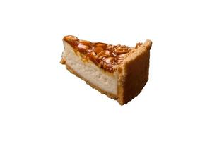 Delicious fresh cheesecake caramel peanut cake with cream and nuts photo