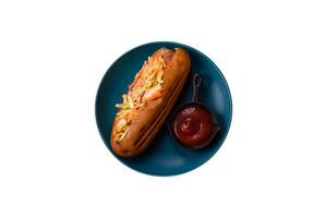 Hotdog with grilled sausage with cabbage, carrots and onions photo