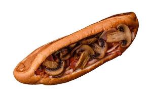 Hotdog with grilled sausage with bacon and mushrooms photo