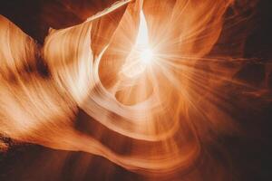 Sunlight entering antelope canyon in arizona, creating stunning light beams photo