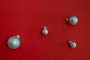 Christmas background. Four silver Christmas balls on a red background. photo