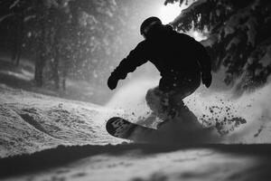 Snowboarder riding down snowy slope at night photo