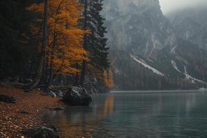 Lago di braies reflecting colorful autumn foliage and majestic mountains in the dolomites photo