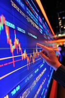 Businessman analyzing stock market data on digital screen photo
