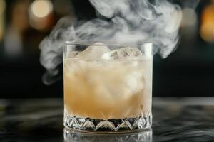 Smoking cocktail glass filled with ice and alcoholic beverage on bar counter photo