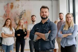 Confident business team posing with arms crossed in modern office photo