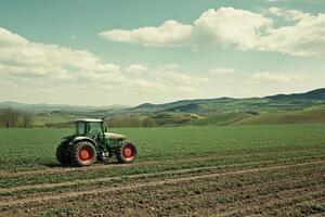 Farmer driving tractor in cultivated field on sunny day photo