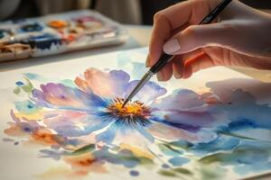 Artist painting colorful flower with watercolor brush photo