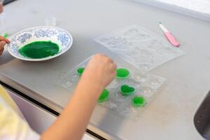 Enthusiastic little girl doing home science project, having a eureka moment. She has chemistry glassware with colorful liquids photo