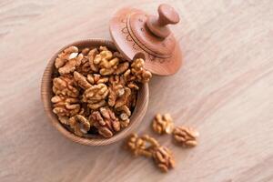 Whole walnuts and split on table. kernels of walnuts are dried and ready to eat. Soft focus. Blured picture. photo