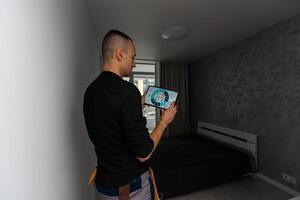 Man using smart home security system control panel photo