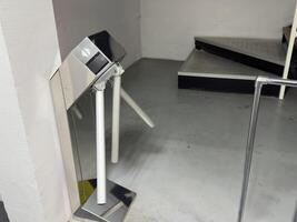 Entrance with turntables. A checkpoint with a turnstile. Turnstile with card reader. Electronic checkpoint. We pass on the territory. Incoming people control. Subway entrance. photo