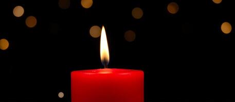 Red Candle Burning with Bokeh Lights in Background photo