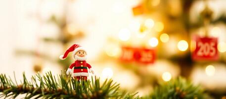cheerful santa figurine on a christmas tree branch photo