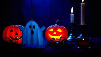 halloween tabletop scene with jack-o'-lanterns a ghost a spider photo