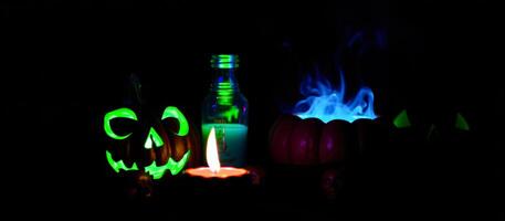 a halloween candle lit up with a pumpkin and a candle photo