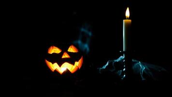 carved pumpkin glows with a lit candle photo