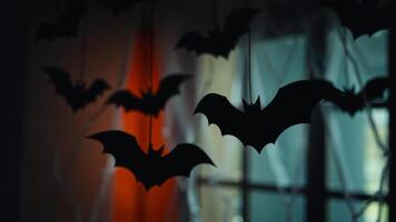 black paper bats hang from ceiling creating a spooky atmosphere photo