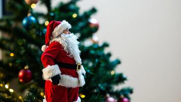festive toy figure stands near a decorated evergreen tree photo