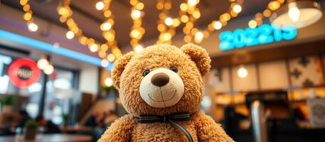 brown teddy bear with a black bow tie sits front a blurred background string lights photo