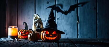 three jack-o'-lanterns with a witch hat candle on a rustic wooden table photo