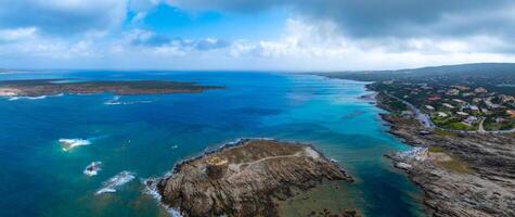 Aerial View of Sardinia's Coastal Cliffs and Ancient Tower photo