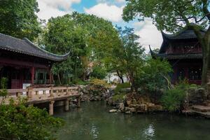 Traditional Chinese Garden with Pavilions and Stone Bridge in Shanghai photo