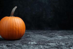 Autumn pumpkin on dark background photo