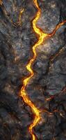 Fiery molten lava flowing through cracks in dark rock photo