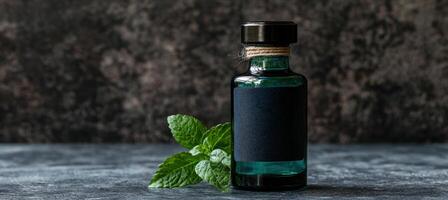 Bottle of green herbal tincture with fresh mint leaves photo