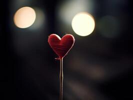 Glowing heart shaped object on a dark background photo