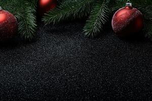 Festive Christmas ornaments and pine branches on a black glittery background photo