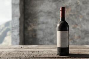 Vintage red wine bottle on rustic wooden table photo