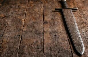 Ornate Sword on Rustic Wooden Surface photo