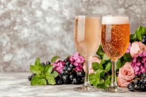 Sparkling wine glasses with fresh berries and flowers photo