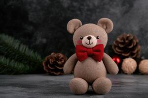 Cute teddy bear with red bow tie in festive winter setting photo