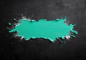 Vibrant teal paint splash on black background photo