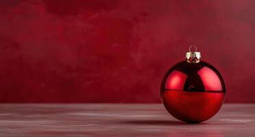 Shiny red christmas ornament on a wooden surface photo
