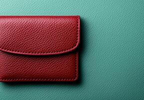 Close up of a red leather wallet on a teal background photo