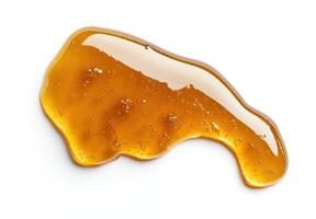 Gooey honey dripping from a spoon photo