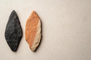 ancient stone tools on plain background photo