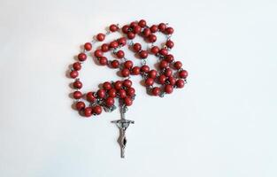 Red rosary on plain background photo