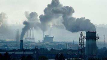 Smoke billowing from chimneys in a factory video