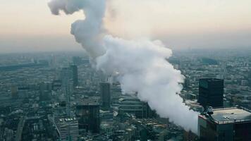Smoke billowing from the top of a building in a city video