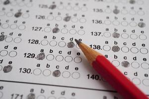 Answer sheets with pencil drawing fill to select choice, education concept. photo