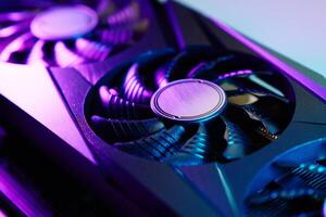 Modern gaming graphics card illuminated by neon lights photo